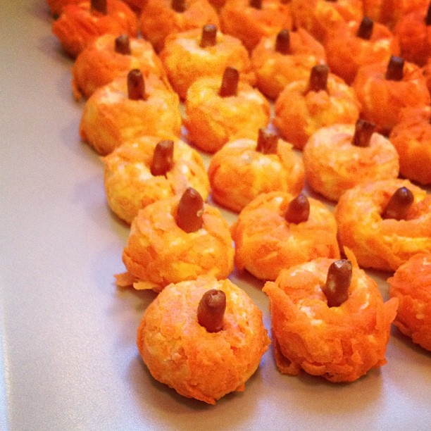 Cream cheese, carrot, and pretzel "pumpkins".